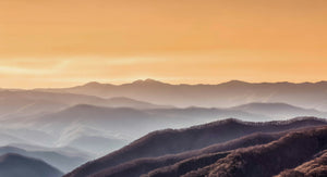 Layered mountain ridges catching the first golden light of sunrise at Newfound Gap in Great Smoky Mountains National Park